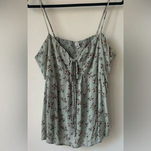 Floral tank top with side cut outs and adjustable cinch in front